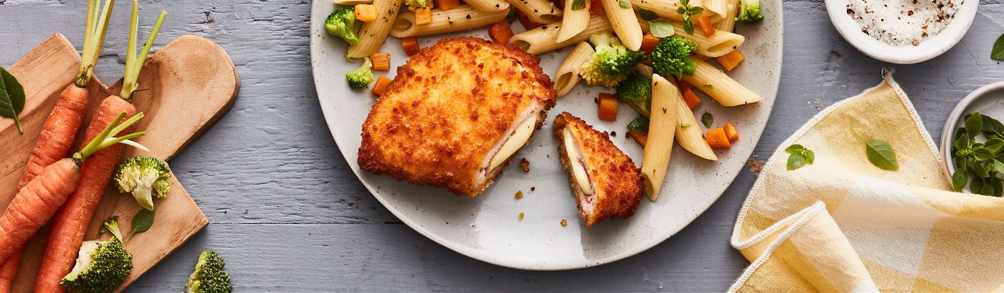 Cordon bleu doré au four accompagné de pâte et de petits légumes carottes et brocolis